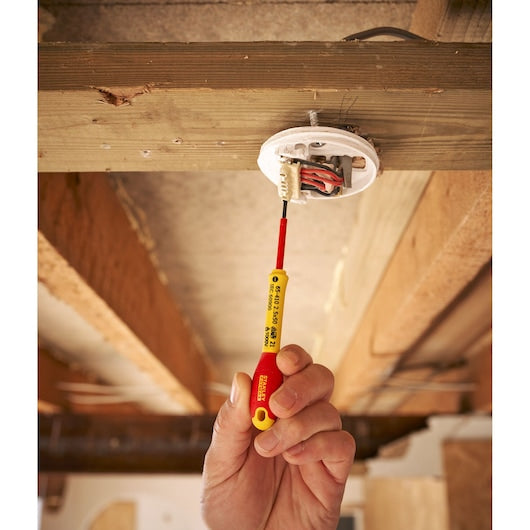 Photo of STANLEY 0-65-410 insulated screwdriver used for wiring installation under wooden ceiling.