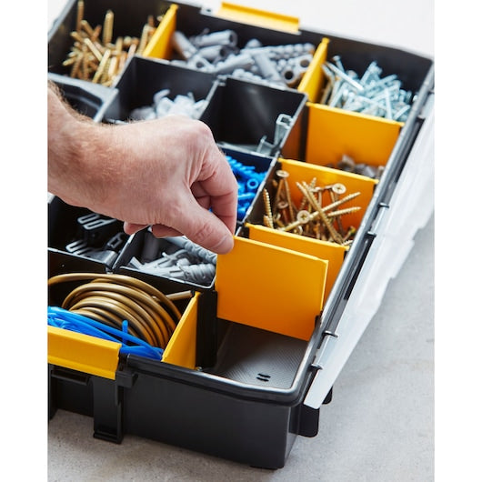 STANLEY 1-94-745 organizer box with adjustable yellow dividers, various screws and wall plugs, close-up angle.