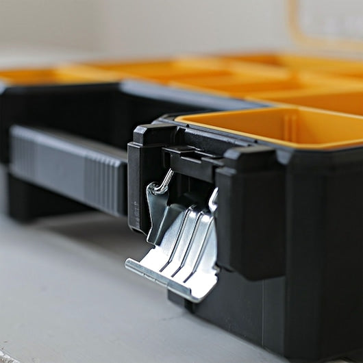 STANLEY 1-97-518 organizer box with yellow compartments, close-up of metal latch, product angled on white background.