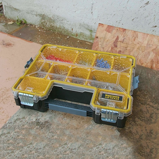 Stanley 1-97-518 organizer with yellow compartments and clear lid shown at outdoor angle.