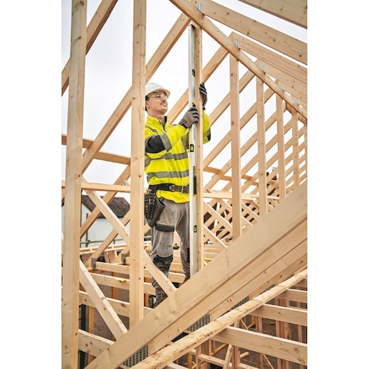 STANLEY FMHT43678-1 spirit level used on a wooden construction frame at a building site.
