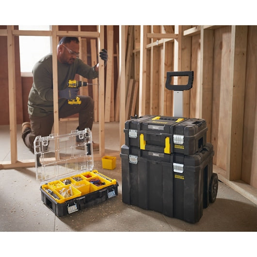 Photo of STANLEY FMST1-80101 modular toolboxes, including an open organizer and stackable rolling cases at a construction site.