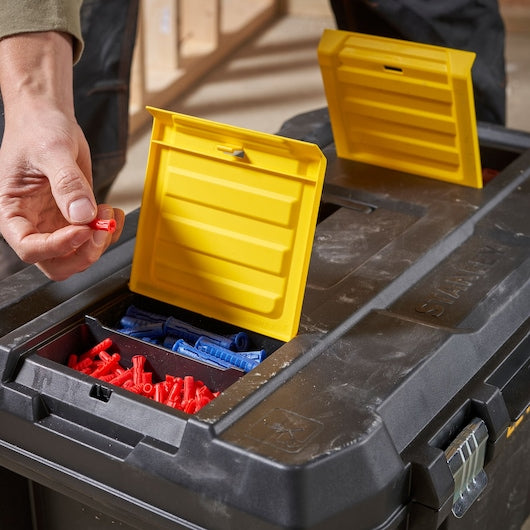 Photo of STANLEY STST1-80150 toolbox with yellow lid compartments storing red and blue wall plugs.