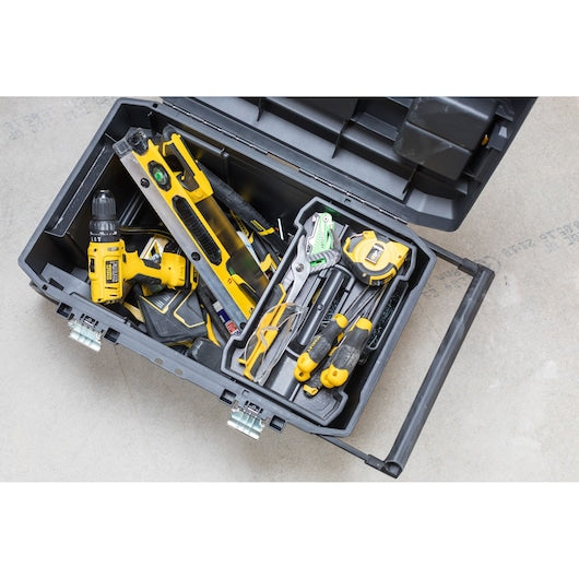 Stanley STST1-80150 rolling toolbox filled with assorted tools, top-down photo on concrete floor.