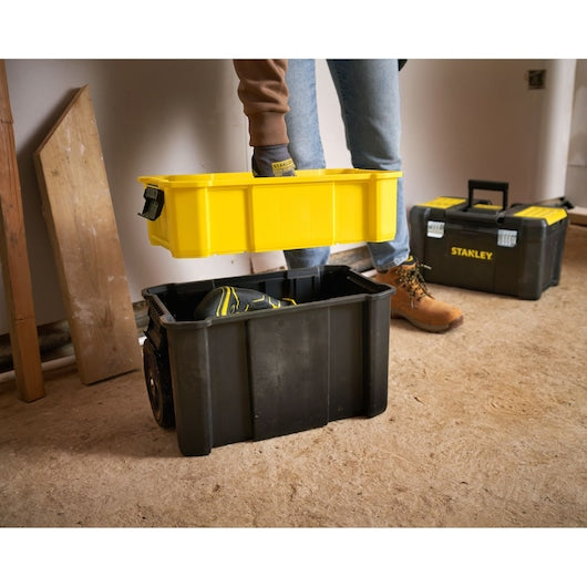 STANLEY STST1-80151 toolbox with yellow tray being lifted, workshop setting, front angle.
