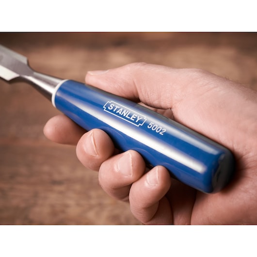 STANLEY 0-16-130 blue handle chisel held in hand, close-up view.