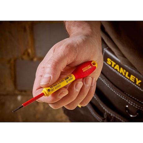 STANLEY 0-65-410 insulated screwdriver held in hand, red and yellow handle, close-up photography.