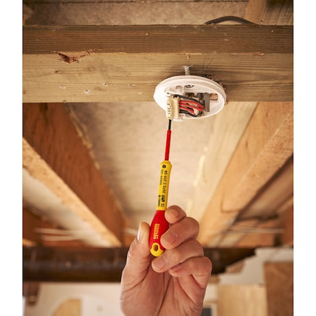 Photo of STANLEY 0-65-410 insulated screwdriver used for wiring installation under wooden ceiling.