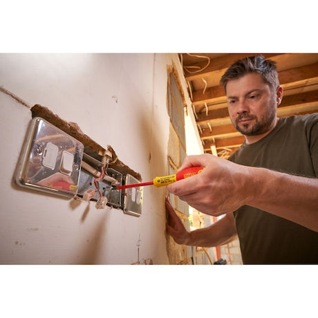 Photo of STANLEY 0-65-415 insulated screwdriver used on an electrical outlet during indoor wiring work.