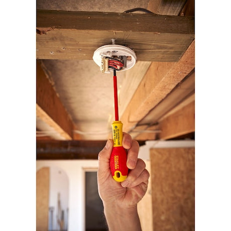 Photo of STANLEY 0-65-415 insulated screwdriver in use on electrical wiring, yellow and red handle.