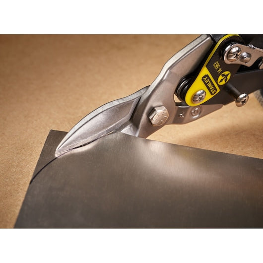 Photo of STANLEY 2-14-563 aviation snips cutting a sheet of metal, close-up view.