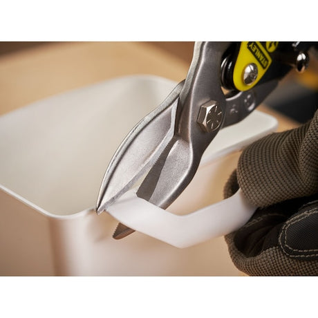 Photo of STANLEY 2-14-563 aviation snips cutting white plastic, close-up view.