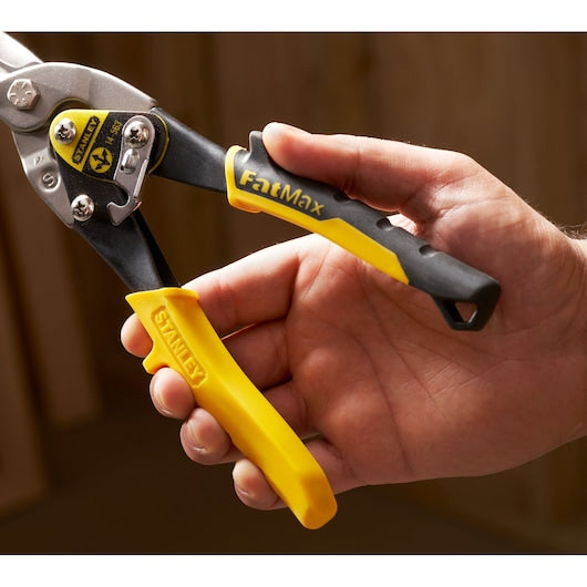 STANLEY 2-14-563 aviation snips with yellow and black FatMax handles, close-up in hand.