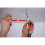 Person using a red and yellow fine screwdriver on electrical wiring in the ceiling.