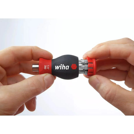 Phillips & Pozidriv – Hands holding a black and red bit holder with multiple bits
