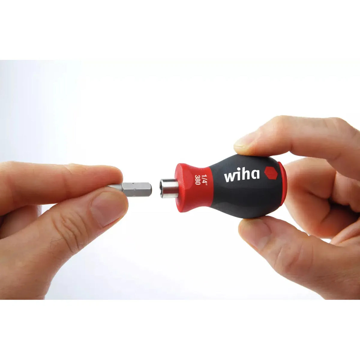 Phillips & Pozidriv – A hand holding a stubby screwdriver with a bit being inserted