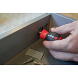 Phillips & Pozidriv – A person uses a red and black screwdriver on a drawer. Bits are placed nearby.