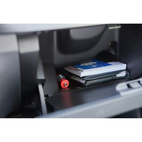 Phillips & Pozidriv – A red-handled screwdriver is in a car glovebox with books and a folder.