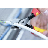 Person using pliers to cut a white cable.