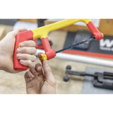 A person adjusts a red and yellow hacksaw with a small knob