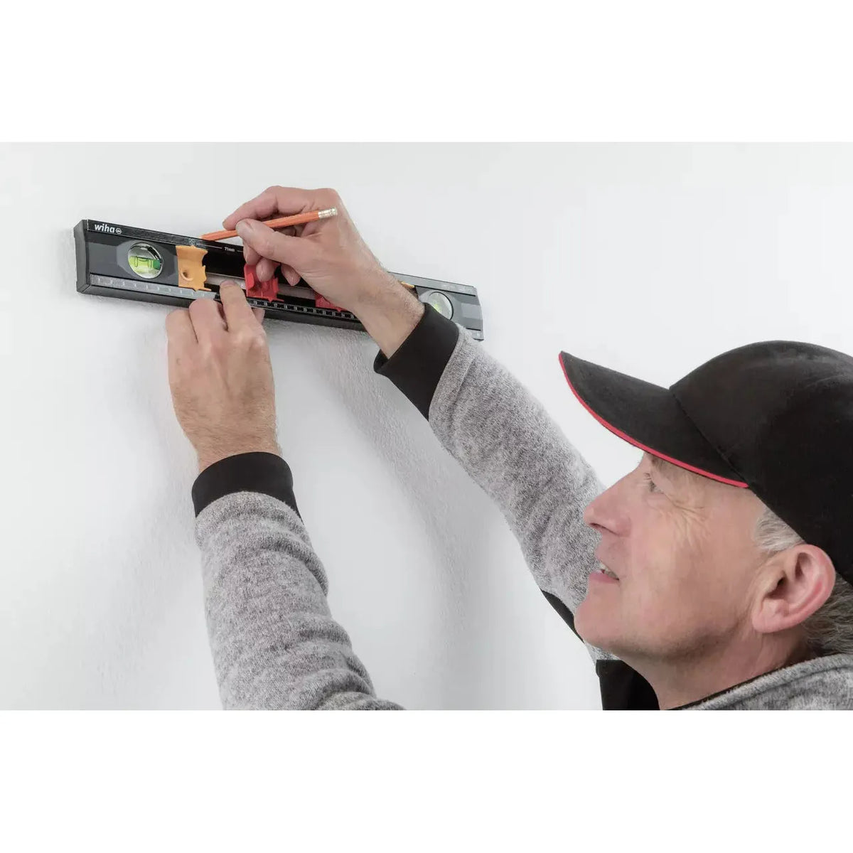 Person using a level on a wall