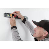 Person using a level on a wall
