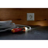 12–1,000V AC – Non-contact voltage detector on table near coiled cable and wall socket.