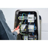 12–1,000V AC – Person using a non-contact voltage detector on electrical panel