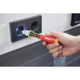 12–1,000V AC – Hand holding a non-contact voltage detector near a power socket.
