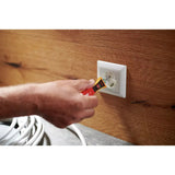 90–1,000V AC – A person uses a non-contact voltage detector near an electrical outlet on a wooden wall.