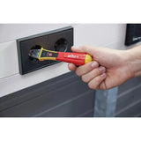 90–1,000V AC – Hand using non-contact voltage detector in power outlet