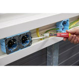 90–1,000V AC – A person using a non-contact voltage detector on a white cable near electrical sockets.