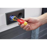 90–1,000V AC – Hand using a non-contact voltage detector near an electrical socket