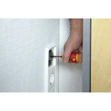A person using a red and yellow screwdriver to work on a wall socket