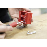 Person using a red magnetizer on a screwdriver tip
