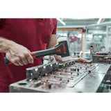 Person using black hammer with white plastic head in workshop