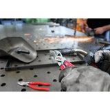 Person using diagonal cutter to trim wire on metal surface
