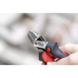 Wire cutter with red and black handles held in a hand.