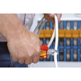 A person using red-handled side cutters to cut a white cable.