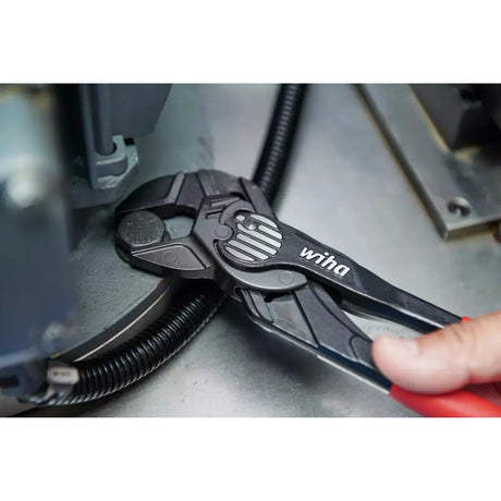 Adjustable wrench gripping a bolt near machinery