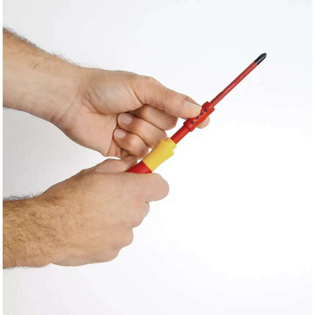 10-piece – Slotted, Phillips & Pozidriv – Hands holding a red and yellow screwdriver with a slim bit.