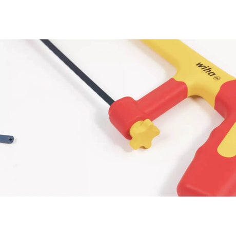 Red and yellow hacksaw with a black blade on a white background.
