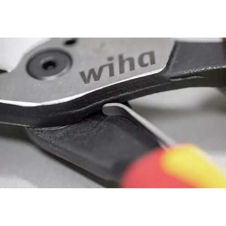 Close-up of pliers with the "wiha" logo on the metal surface.