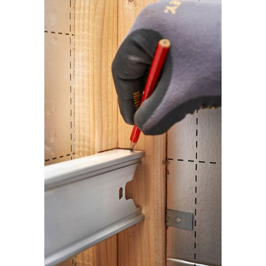 STANLEY FMHT43678-1 photography of gloved hand marking wood with red pencil near metal rail.