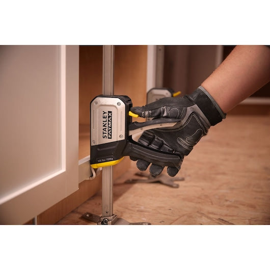 STANLEY FMHT83550-1 cabinet clamp in use, close-up angle, black and silver tool with yellow lever.