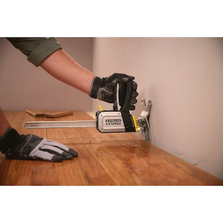 Photo of STANLEY FMHT83550-1 clamp holding wood flooring in place during installation.
