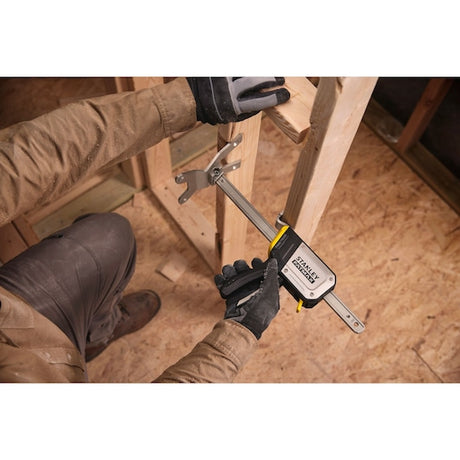 Photo of STANLEY FMHT83550-1 bar clamp in use, securing wooden beams during construction.