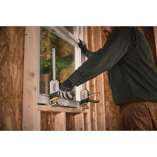 STANLEY FMHT83550-1 photography of carpenter using quick clamp on window frame installation.