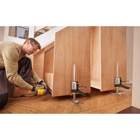 STANLEY FMHT83550-1 support clamp used to hold wooden panels in place during assembly on hardwood floor.