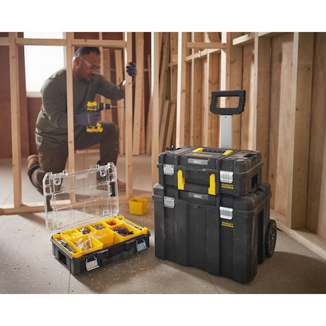 Photo of STANLEY FMST1-80101 modular toolboxes, including an open organizer and stackable rolling cases at a construction site.